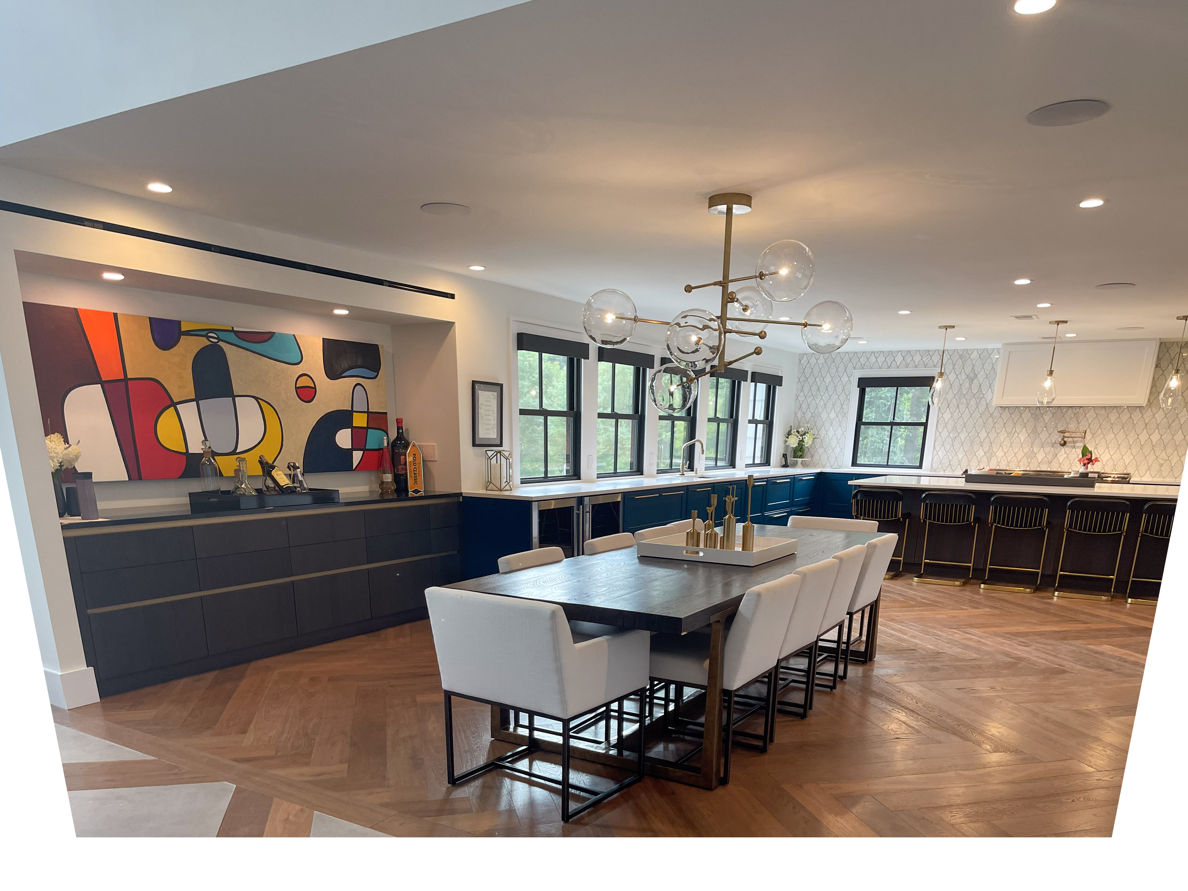 Dining table with white upholstered chairs and dark wood bar cabinetry