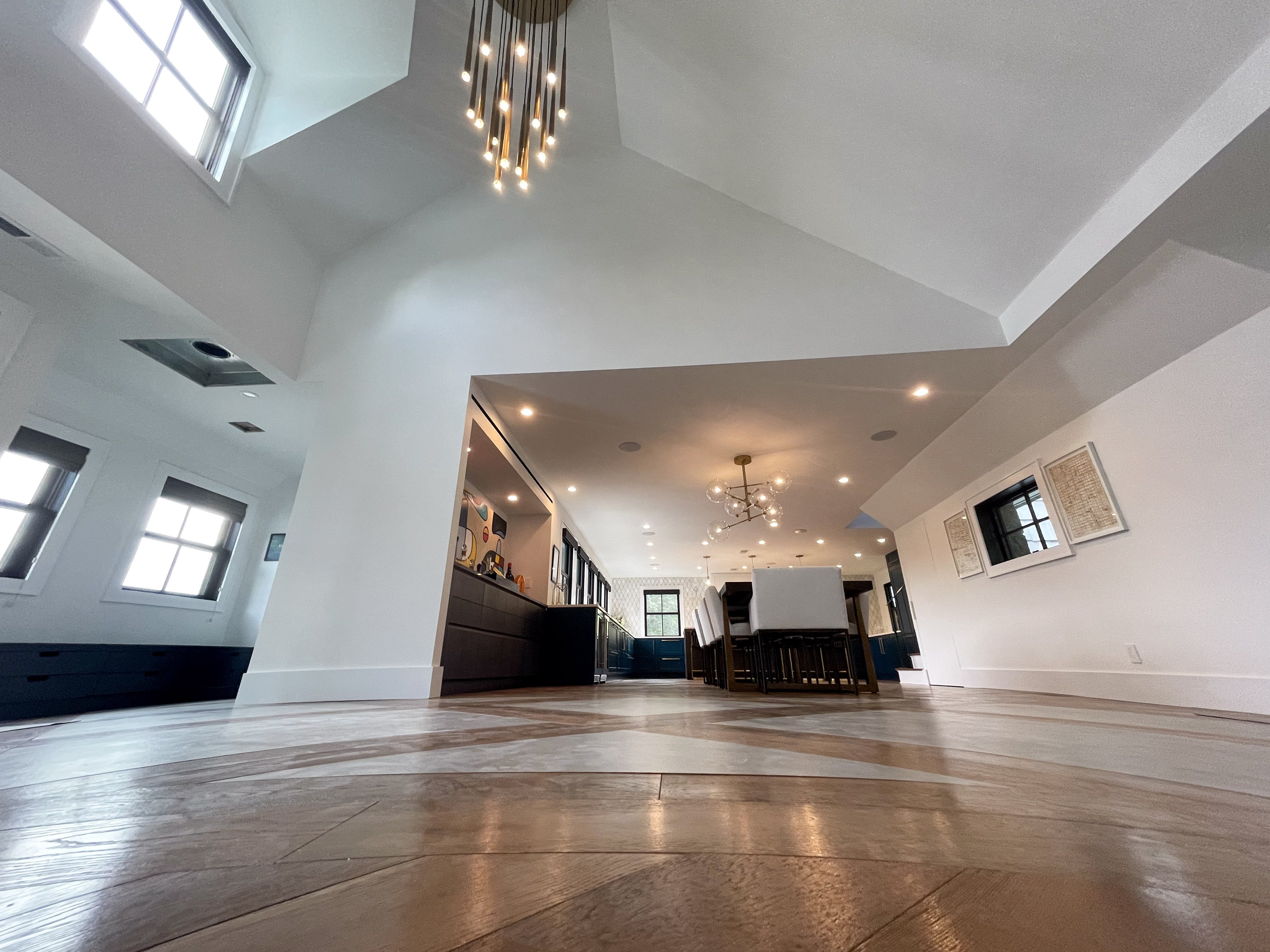 Entry foyer with statement pendant light and herringbone floors