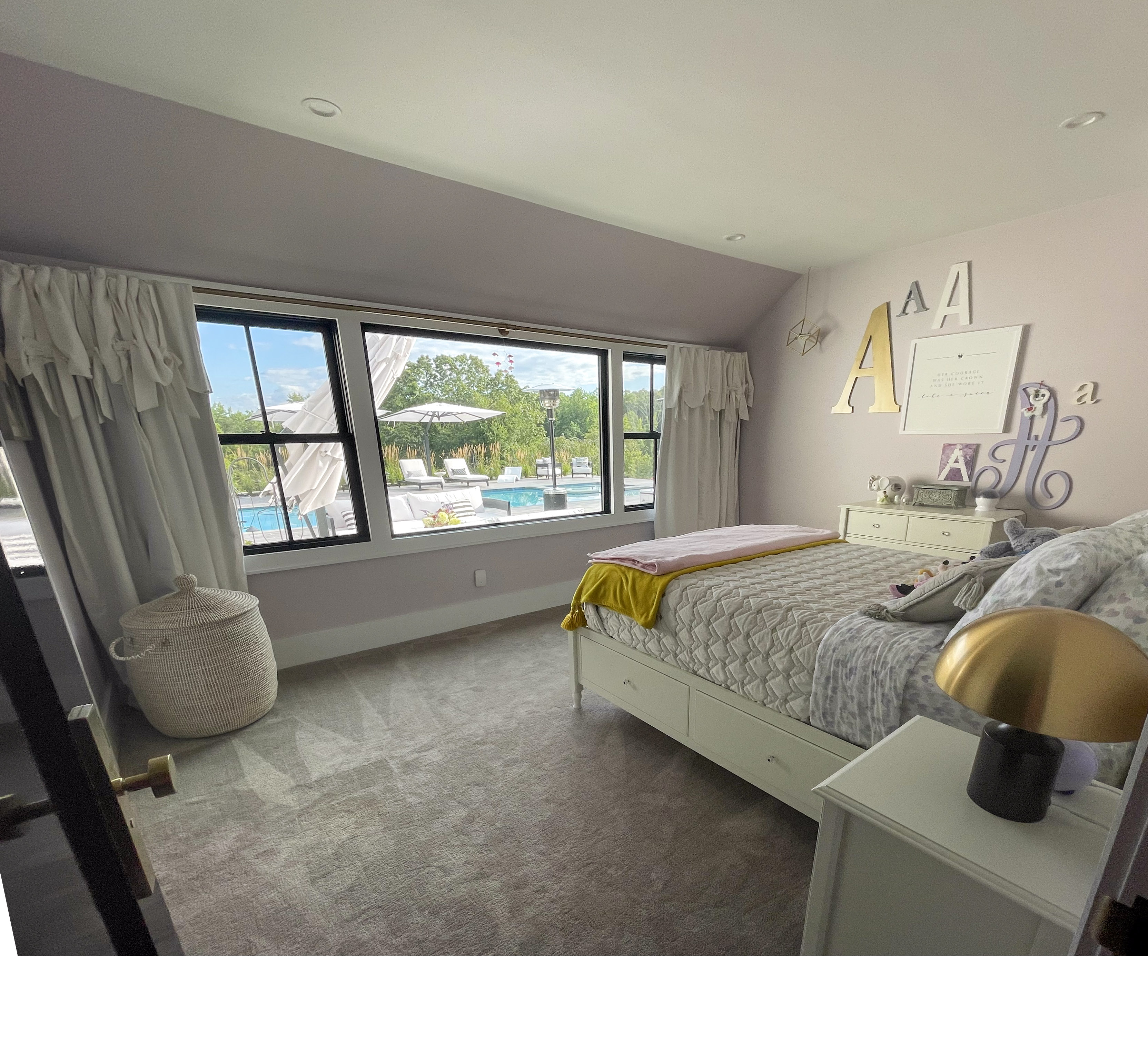 Girl's bedroom in soft lavender with a pool view