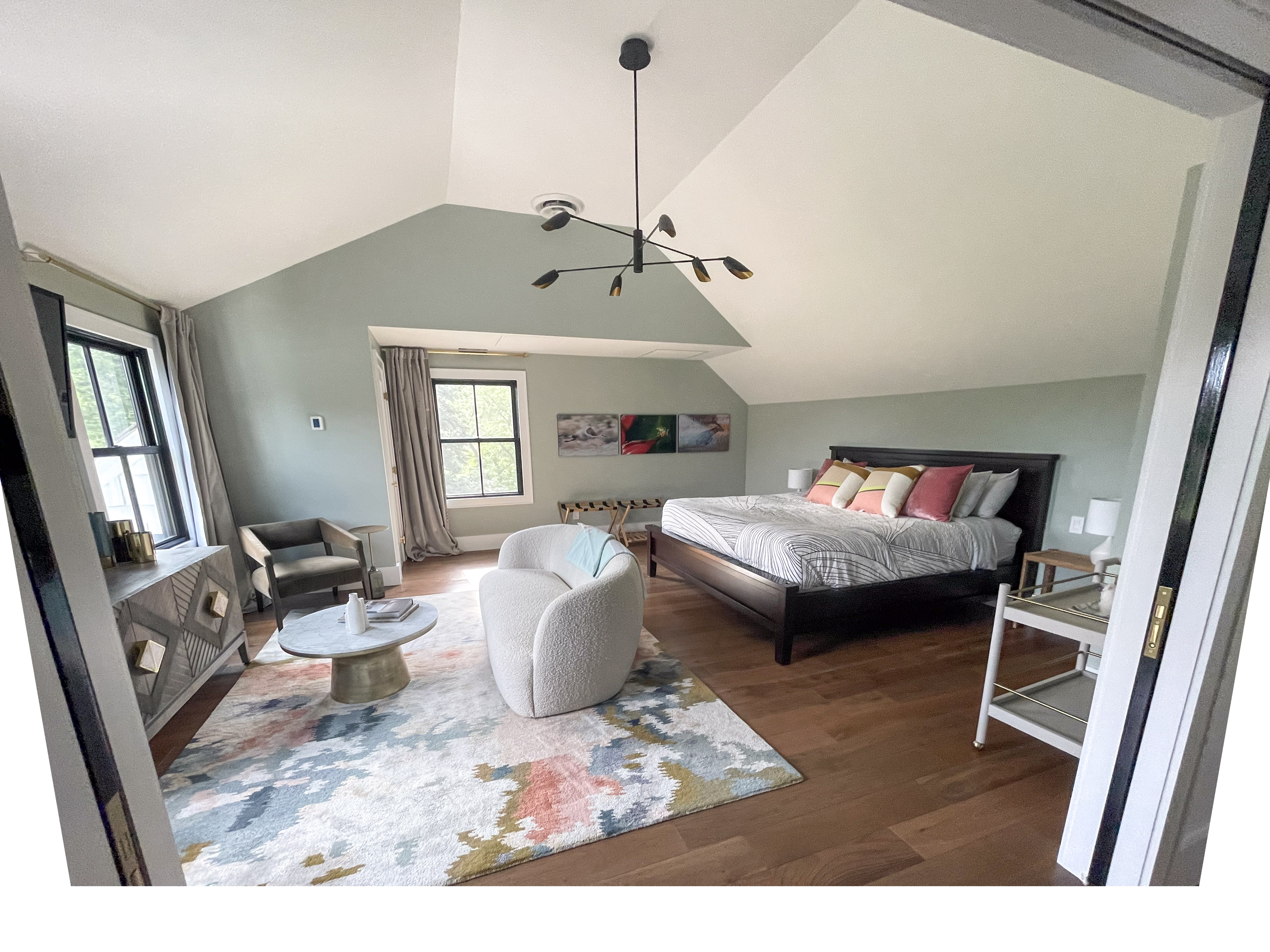 Guest bedroom with sage green walls and a boucle accent chair