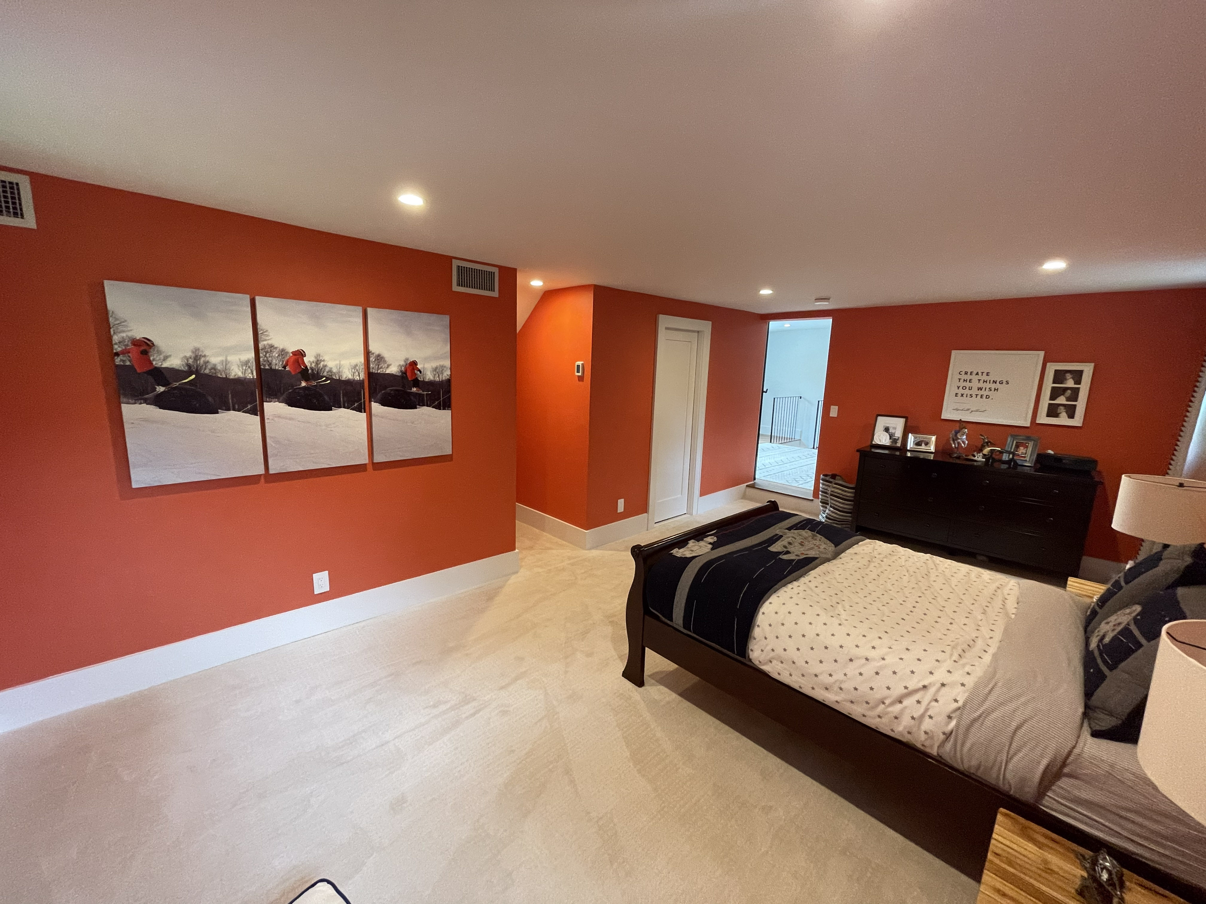 Kids bedroom with terracotta walls and ski-themed art