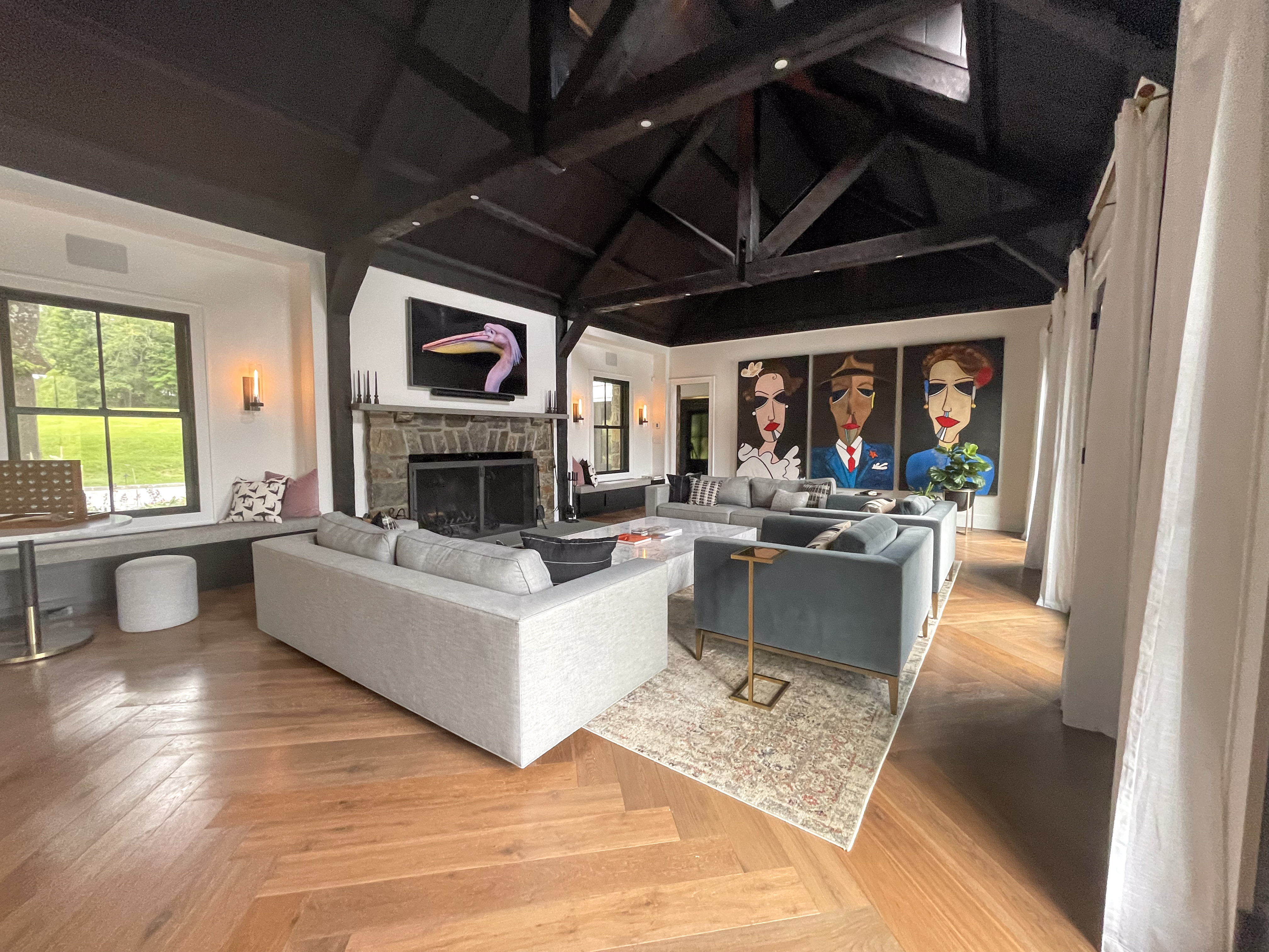 Living room with grey sectional sofas and a stone fireplace