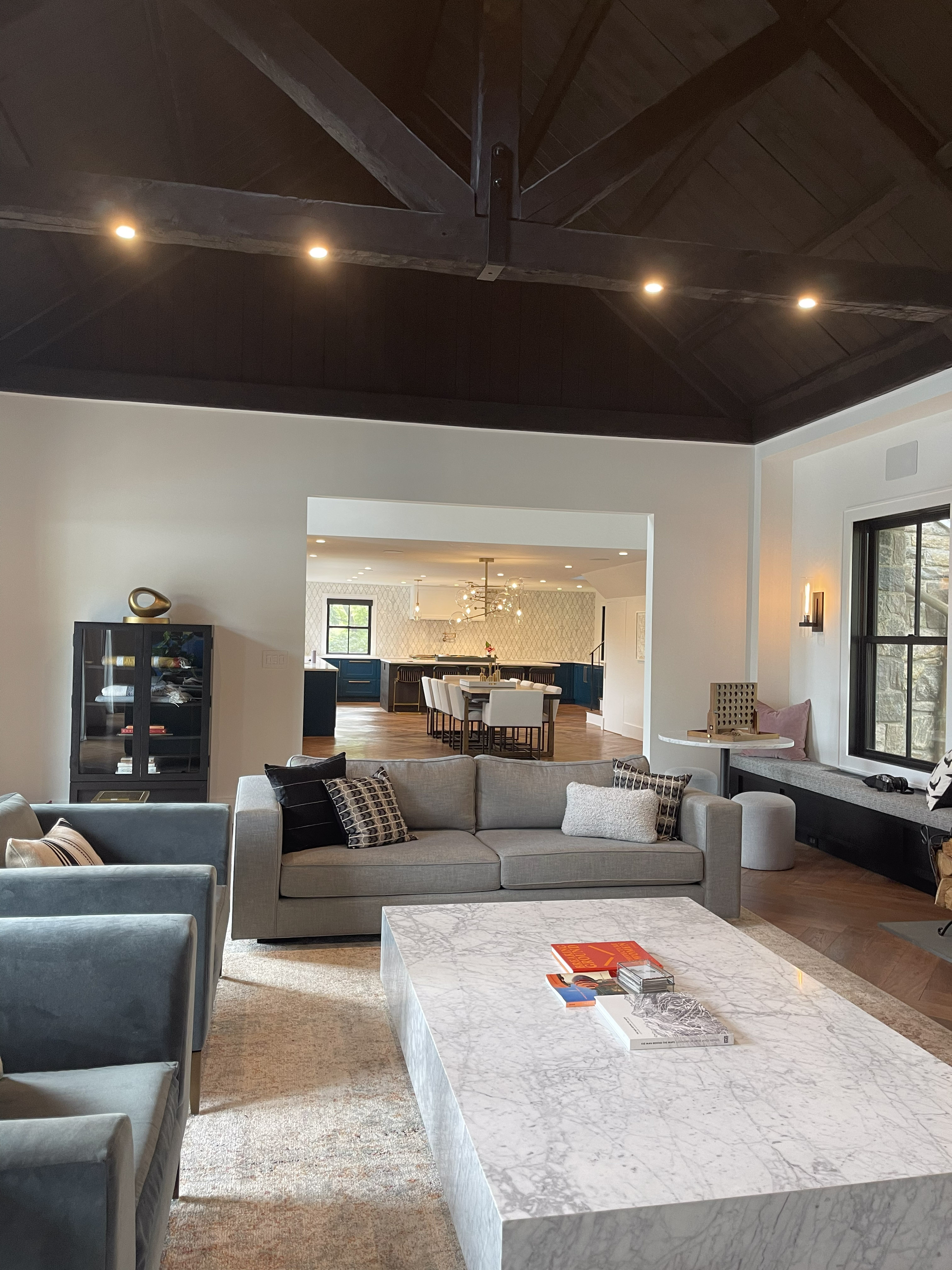 Living room with marble coffee table and dark timber ceiling beams